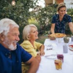 Photo of a senior couple, having dinner at the garden