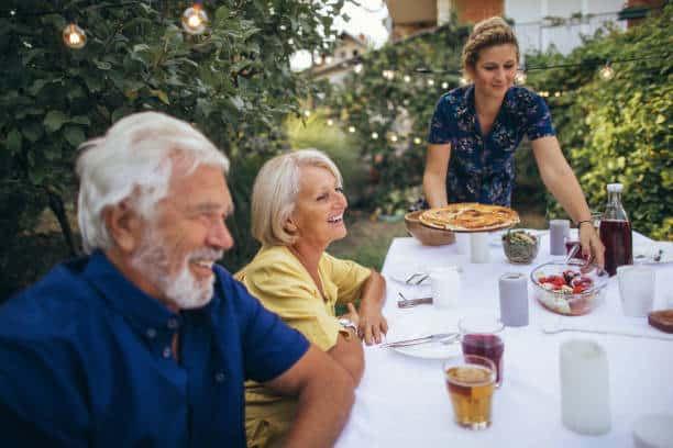 Photo of a senior couple, having dinner at the garden