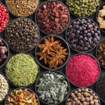 Fresh spices and herbs for food. Colorful condiments as background, top view. lot seasonings in cups, on table